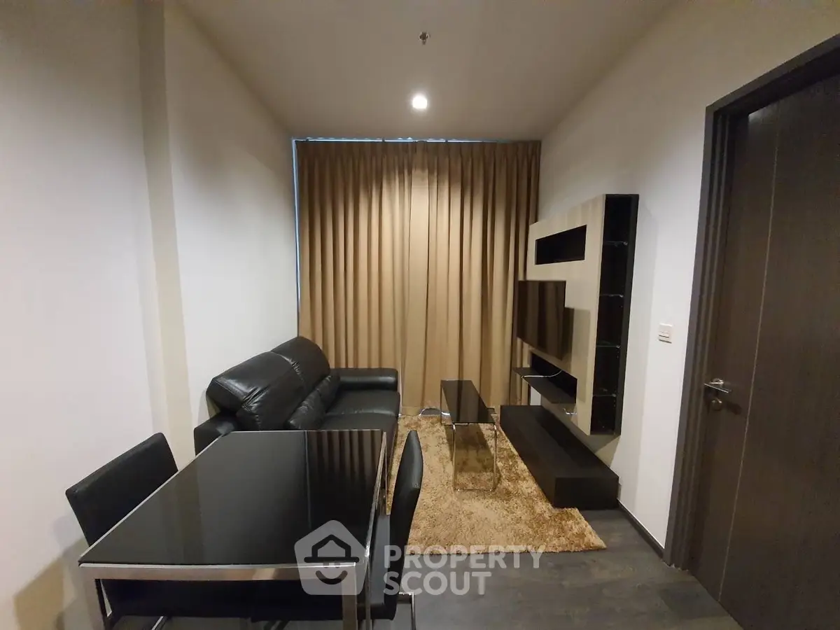 Modern living room with sleek black furniture and stylish shelving unit