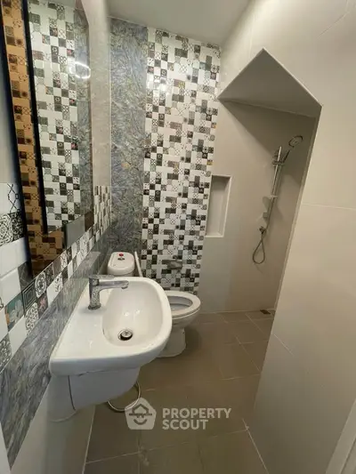 Modern bathroom with stylish tile design and sleek fixtures.