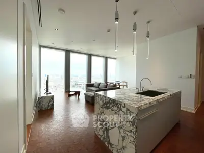 Luxury open-plan living room with stunning city view and modern kitchen island.
