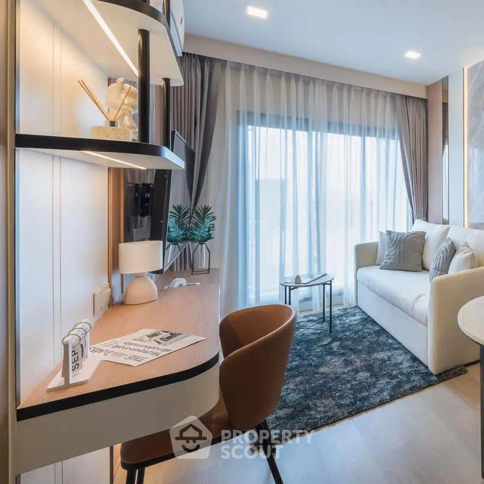 Modern living room with stylish decor and natural light, featuring a cozy sofa and a sleek workspace.