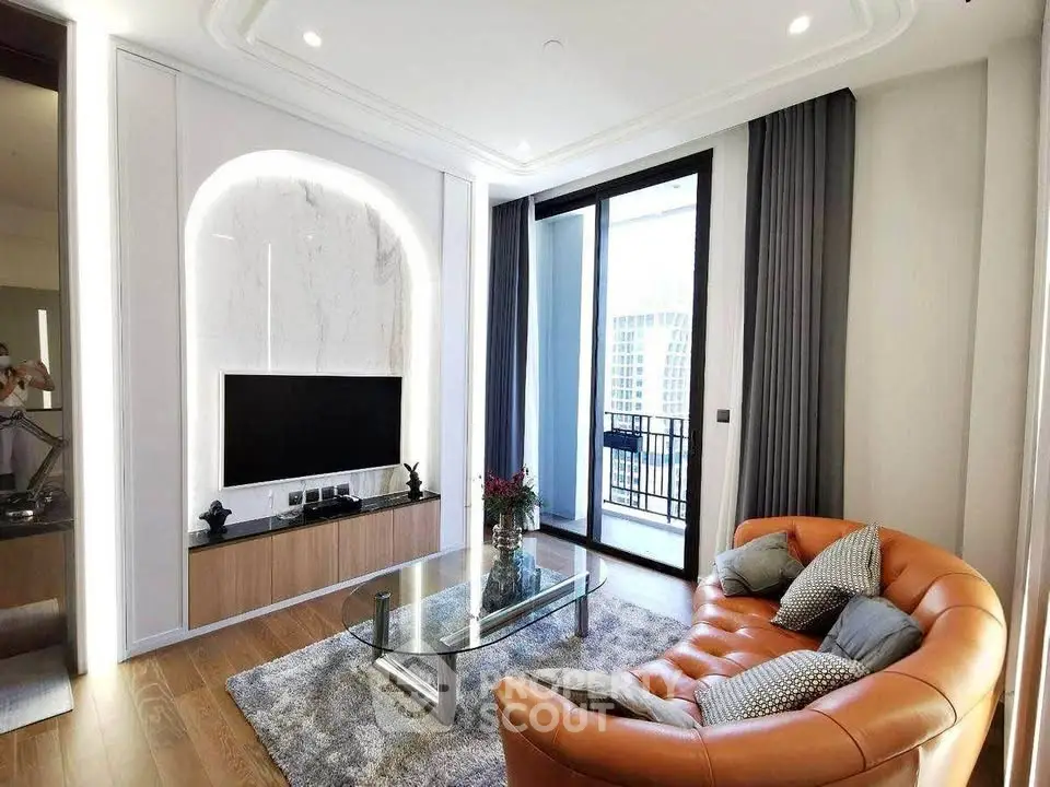 Modern living room with stylish decor and balcony access in luxury apartment.