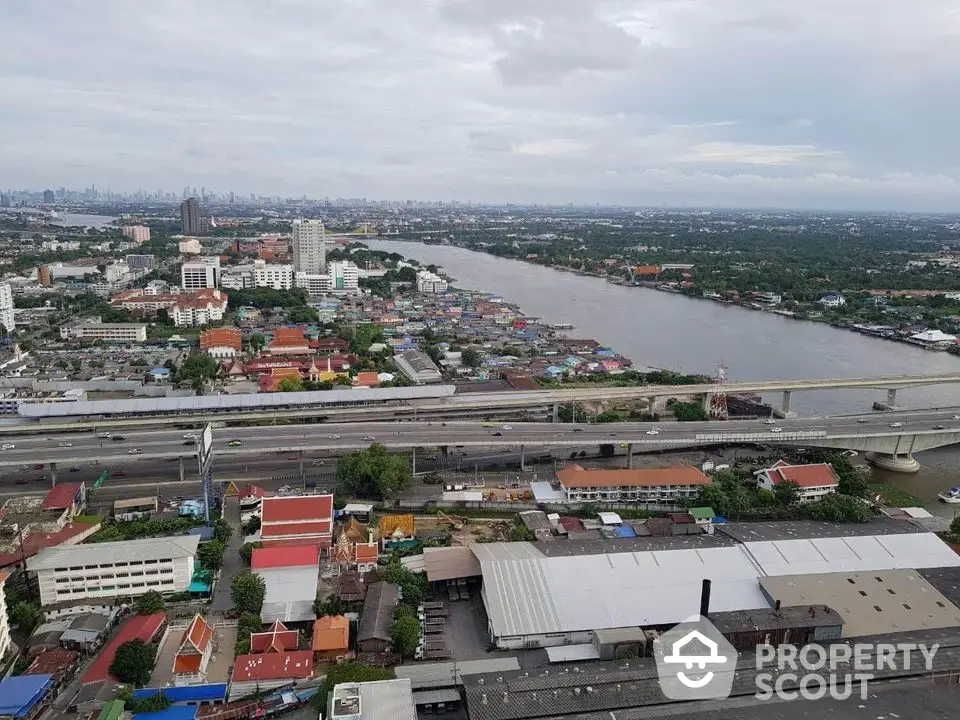 Stunning river view from high-rise building showcasing urban landscape and skyline.