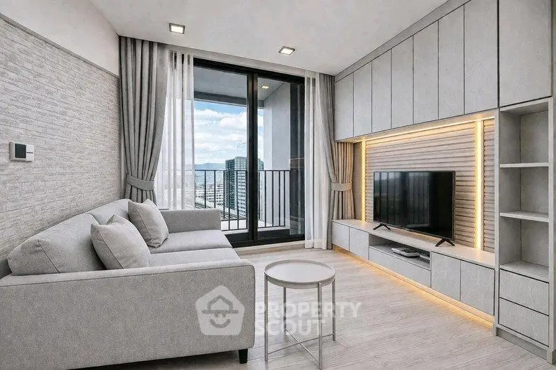 Modern living room with sleek design, large windows, and balcony access in a high-rise apartment.