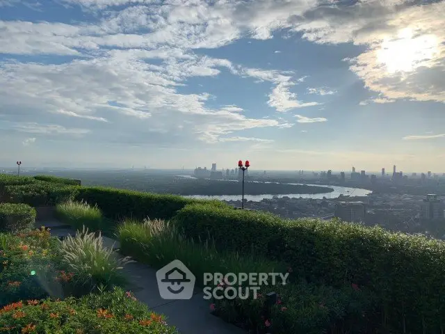 Stunning rooftop garden with panoramic city skyline and river view, perfect for relaxation and entertainment.