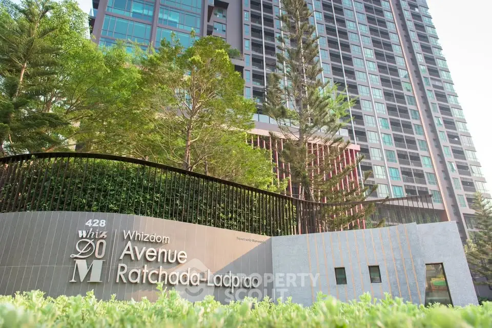 Modern high-rise condominium with lush greenery at Whizdom Avenue Ratchada-Ladprao.