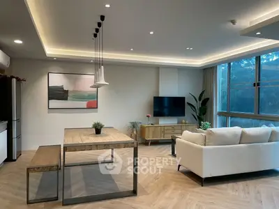 Modern living room with stylish furniture and large window view