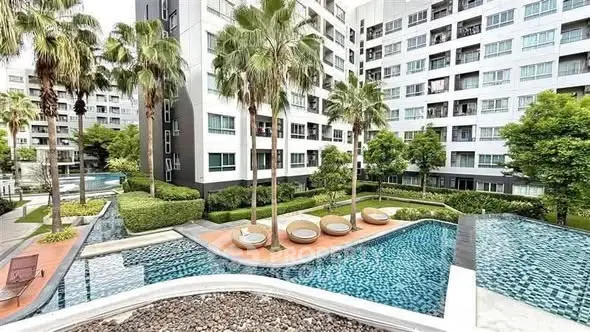 Luxurious apartment complex with stunning pool and lush landscaping