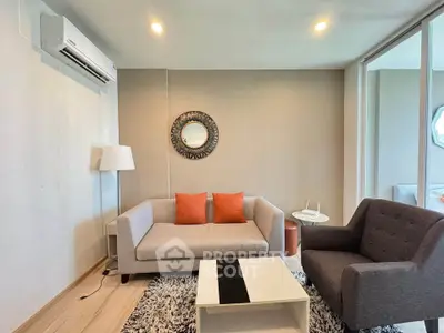 Modern living room with stylish furniture and air conditioning, perfect for relaxation and comfort.