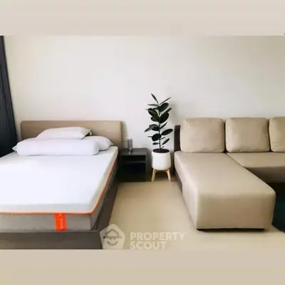 Modern bedroom with stylish bed and cozy sofa, perfect for relaxation and comfort.