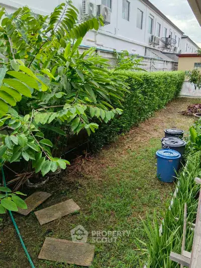 Charming garden area with lush greenery and neat hedges, perfect for relaxation and outdoor activities.