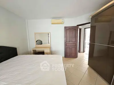 Spacious bedroom with modern furniture and air conditioning unit