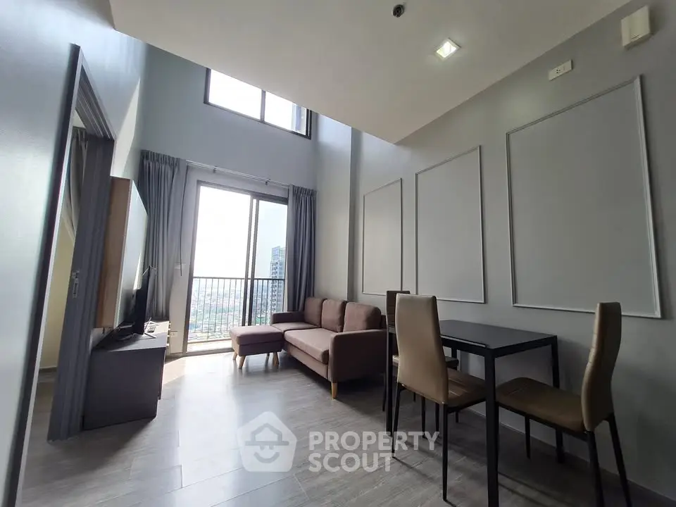 Modern high-ceiling living room with large windows and city view