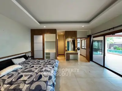 Spacious bedroom with pool view and modern decor