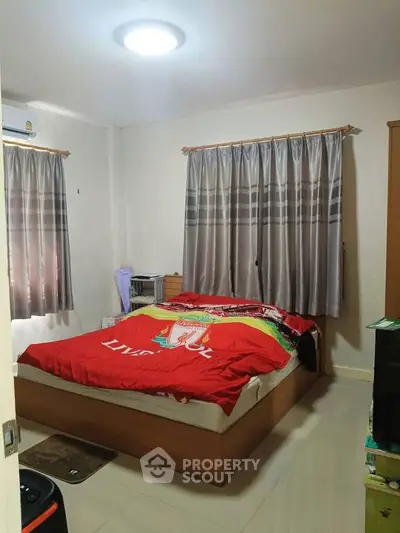 Cozy bedroom with natural light and modern decor, perfect for relaxation and comfort.