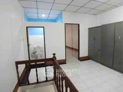 Spacious bedroom with attached bathroom and ample storage space.