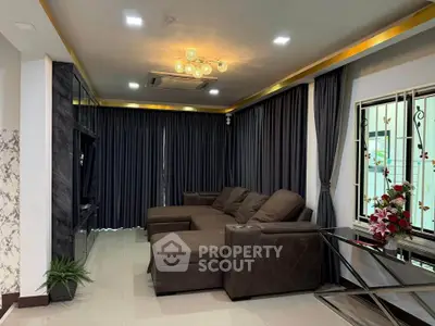 Luxurious living room with elegant dark curtains and plush sectional sofa, perfect for relaxation and entertainment.