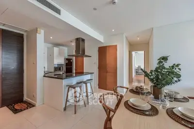 Modern open-plan kitchen and dining area with sleek design and natural lighting.