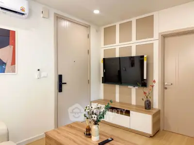 Modern living room with stylish TV setup and wooden furniture, perfect for cozy relaxation.
