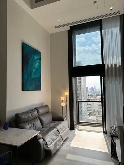 Modern living room with high ceiling and city view, featuring a leather sofa and large windows.