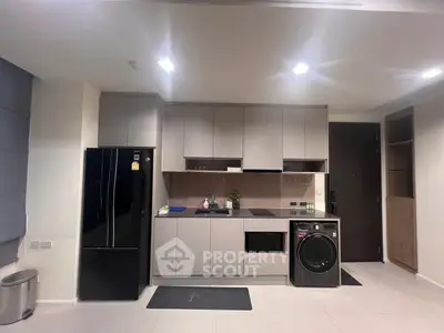 Modern kitchen with sleek cabinetry, built-in appliances, and stylish lighting in a contemporary apartment.