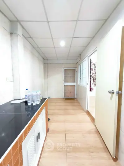 Spacious hallway with modern flooring and ample natural light