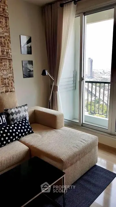 Modern living room with cozy sofa and city view balcony in high-rise apartment.