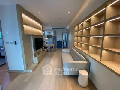 Modern living room with built-in shelves and cozy sofa in stylish apartment.