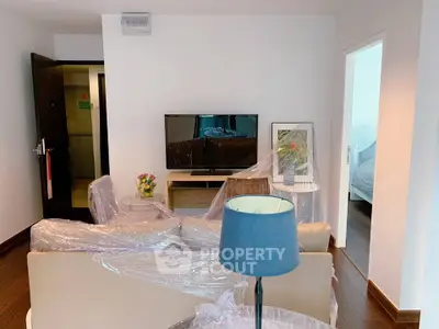 Modern living room with TV and stylish furniture in a cozy apartment.