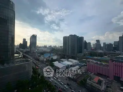 Stunning cityscape view from high-rise building with bustling streets and skyline.