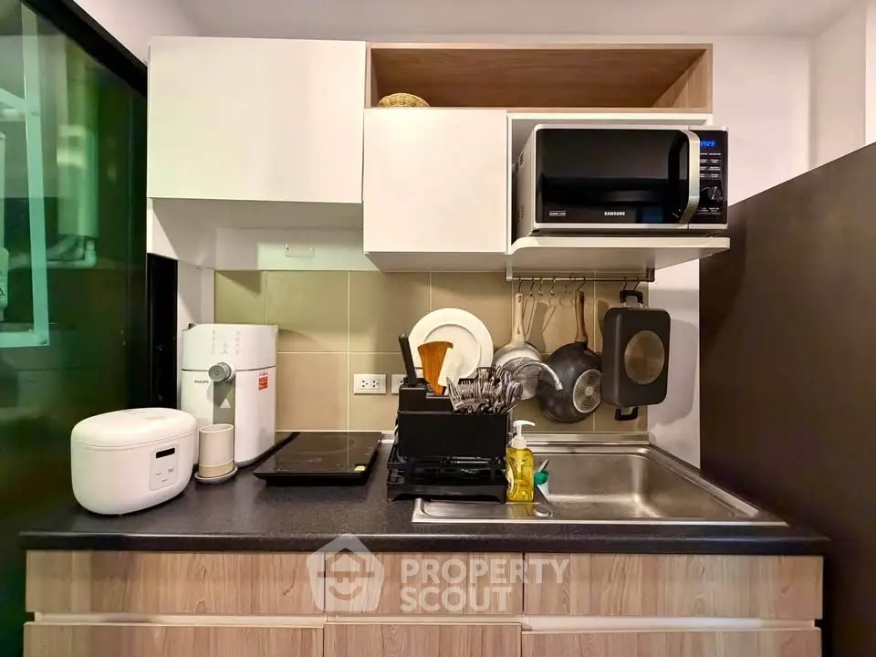 Compact modern kitchen with sleek appliances and efficient storage solutions.