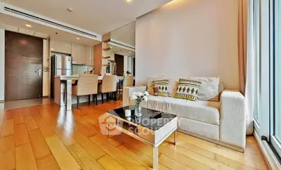Spacious modern living room with open kitchen and elegant decor in a luxury apartment.
