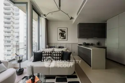 Modern living room with open kitchen, stylish decor, and city view from large windows.