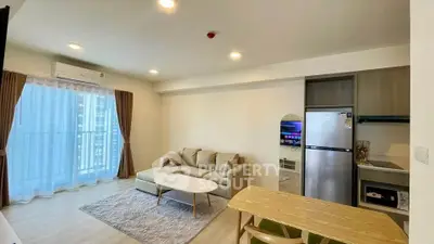 Modern living room with cozy sofa, dining table, and balcony view in a stylish apartment.