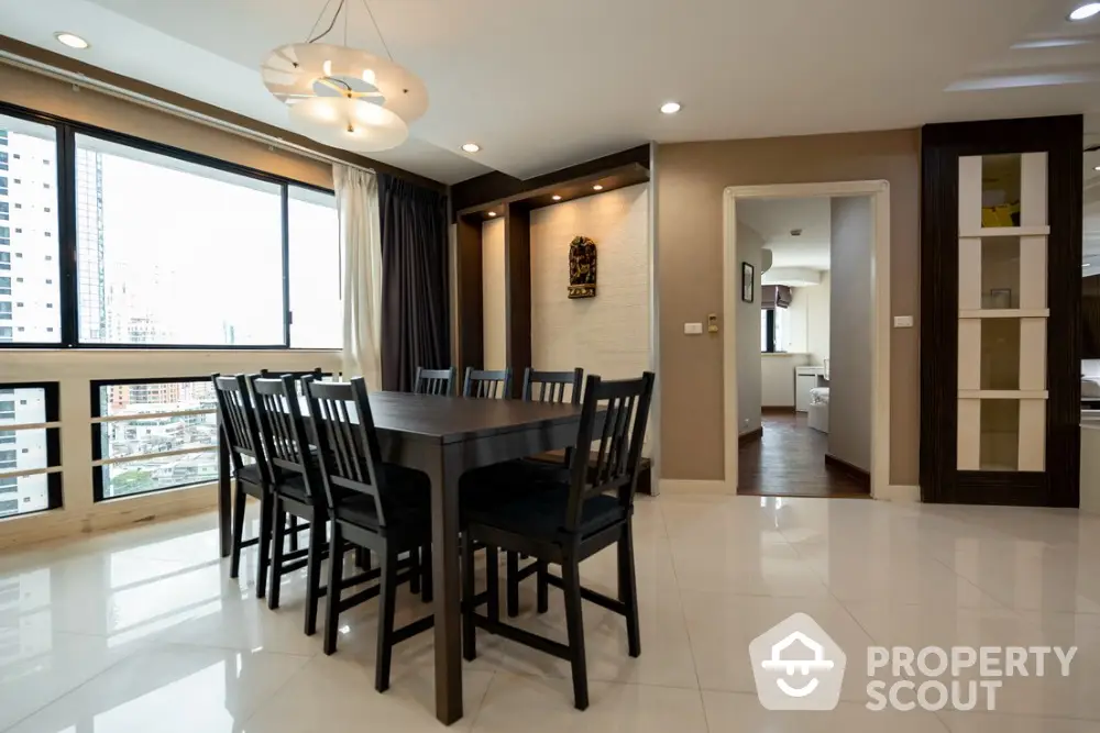 Spacious dining area with modern decor and large windows offering city views