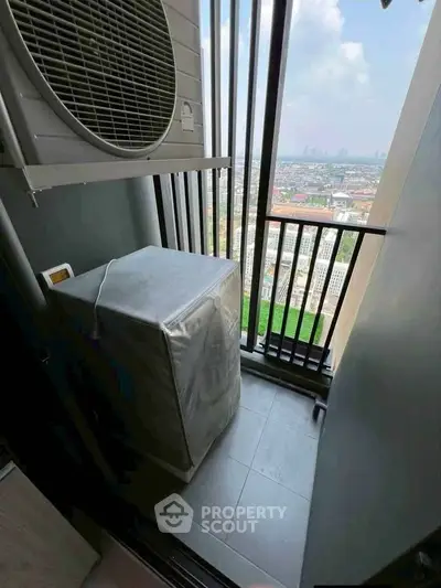 Compact balcony with city view and air conditioning unit, ideal for urban living.