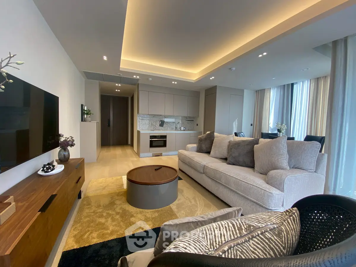Luxurious open-plan living room with modern kitchen and cozy seating area, perfect for entertaining.