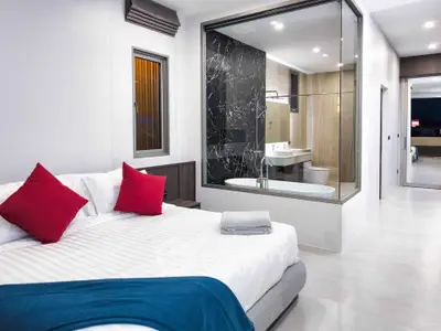 Luxurious bedroom with ensuite bathroom featuring modern design and elegant decor.