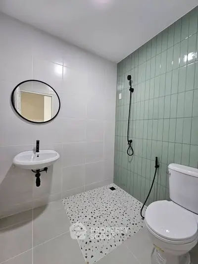Modern bathroom with stylish green tiles and sleek fixtures