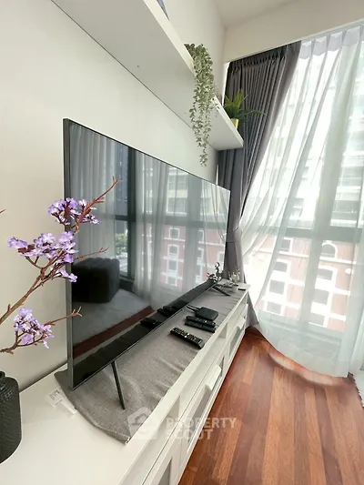 Modern living room with sleek TV setup and large window view