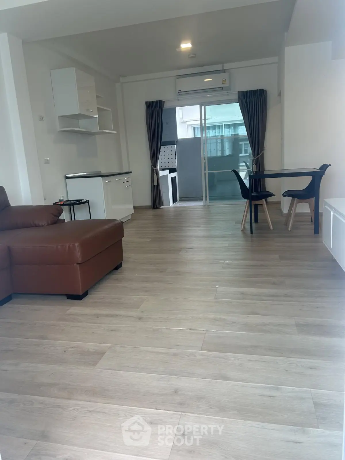 Spacious modern living room with open layout and stylish furniture, perfect for contemporary living.