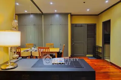 Elegant dining area with wooden flooring and modern decor in a cozy apartment.