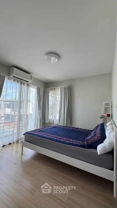 Bright and airy bedroom with large windows and modern decor