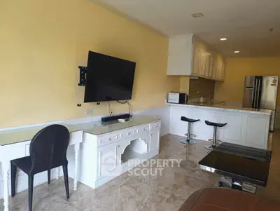 Spacious open-layout kitchen and living area with modern appliances and elegant furnishings.