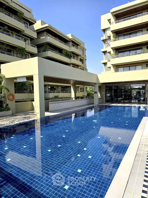 Luxurious residential complex with a stunning outdoor pool and modern architecture.