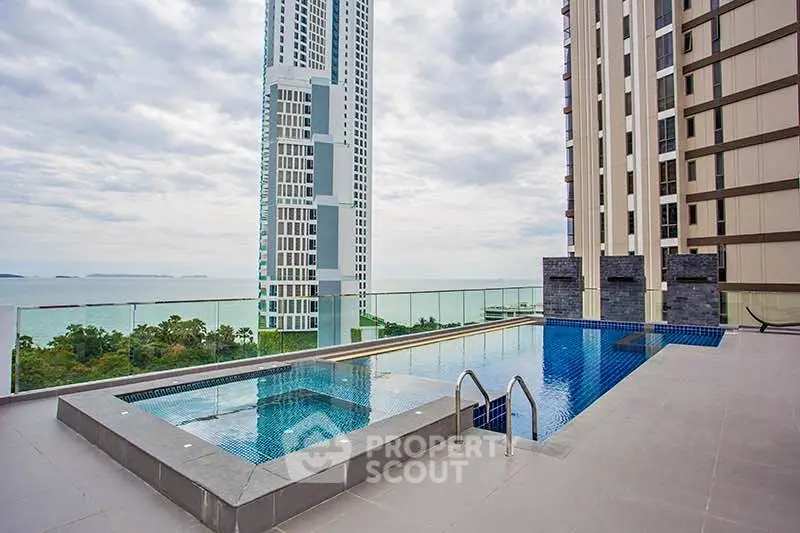 Luxurious rooftop pool with stunning ocean view in modern high-rise building.
