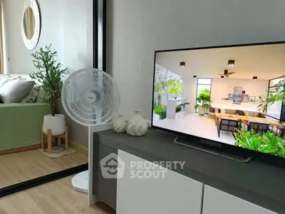 Modern living room with stylish decor and large TV displaying interior design.