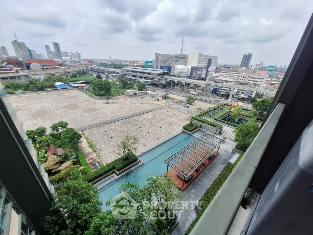 Stunning urban view from high-rise balcony overlooking cityscape and modern architecture.