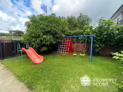 Charming backyard with playground set and lush greenery, perfect for family fun and relaxation.