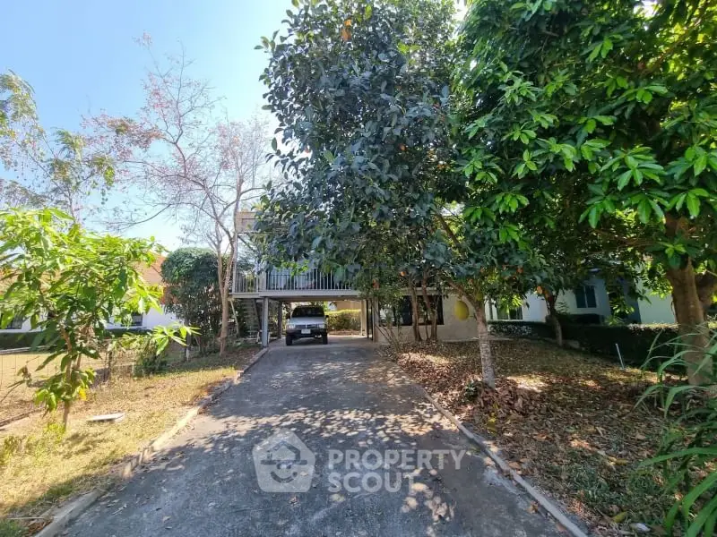 Charming house with lush garden and spacious driveway, perfect for serene living.