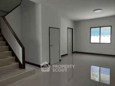 Spacious modern interior with sleek staircase and natural light